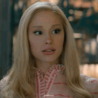 A Close Up Of A Blonde Woman Wearing A Pink Shirt GIF