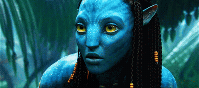 A Close Up Of A Blue Alien With Yellow Eyes GIF