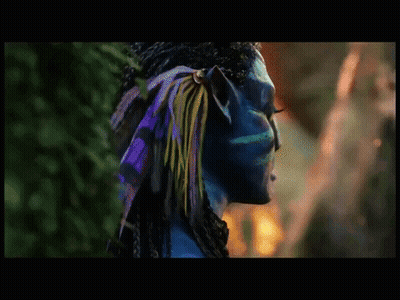 A Close Up Of A Blue Avatar With A Green Eye GIF