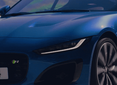 A Close Up Of A Blue Car With The Letter R On It GIF