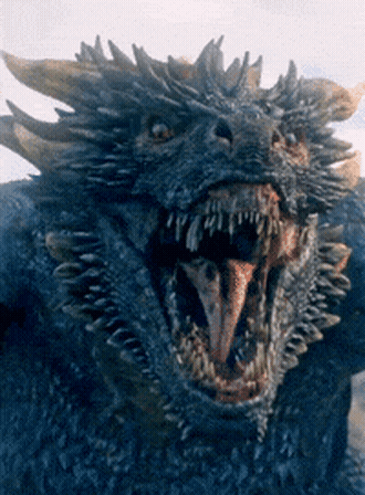 A Close Up Of A Blue Dragon With Its Mouth Open GIF