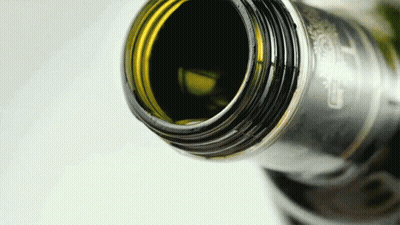 A Close Up Of A Bottle With A Label That Says Carlsberg On It GIF