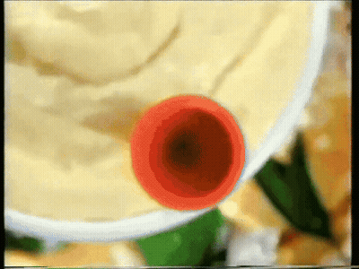 A Close Up Of A Bowl Of Mashed Potatoes With A Red Object In It GIF
