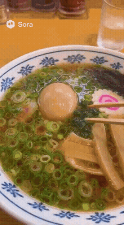 A Close Up Of A Bowl Of Ramen With A Picture Of Sora On The Bottom GIF