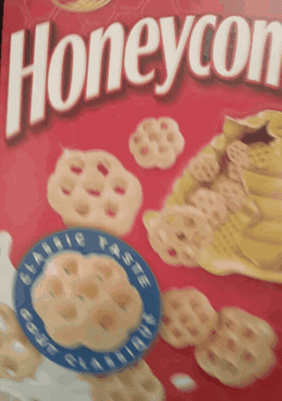 A Close Up Of A Box Of Honeycomb Cereal With A Blue Label GIF