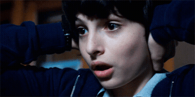 A Close Up Of A Boy Covering His Ears With His Hands GIF