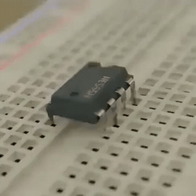 A Close Up Of A Breadboard With A Chip On It . GIF