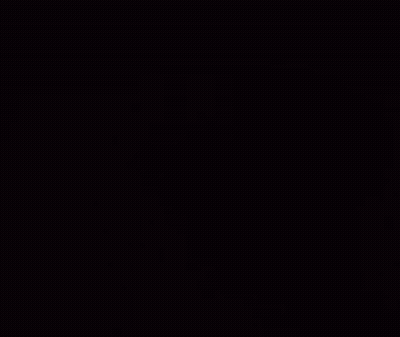 A Close Up Of A Brown Dog 'S Face With A Field In The Background GIF