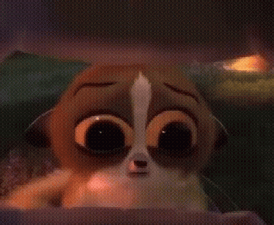 A Close Up Of A Cartoon Animal With Big Eyes Looking Out Of A Box . GIF