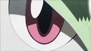 A Close Up Of A Cartoon Character 'S Eye With A Green Leaf On It . GIF