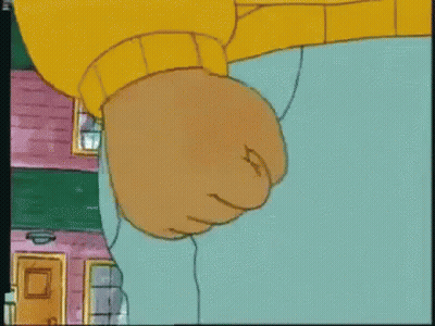A Close Up Of A Cartoon Character 'S Fist In A Yellow Sweater GIF