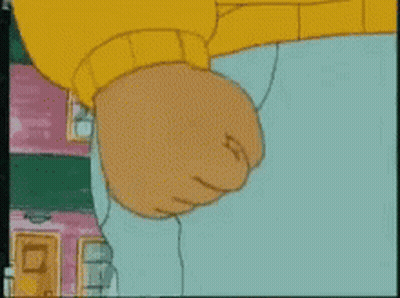 A Close Up Of A Cartoon Character 'S Fist With A Yellow Sweater On GIF