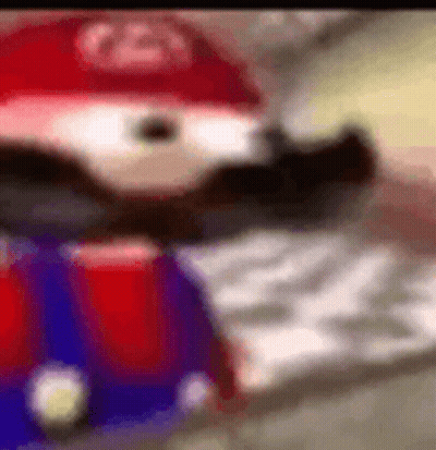 A Close Up Of A Cartoon Character Wearing A Red Hat And A Beard . GIF