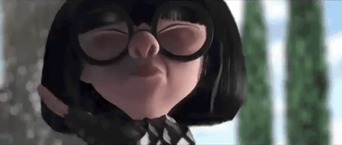 A Close Up Of A Cartoon Character Wearing Glasses Making A Face . GIF