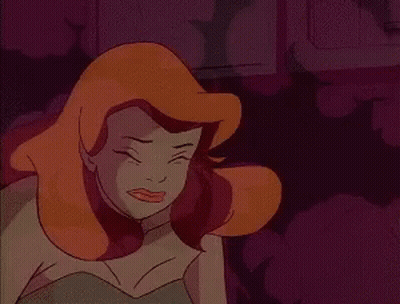 A Close Up Of A Cartoon Character With Red Hair And A Green Dress . GIF