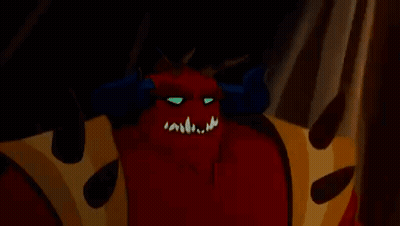 A Close Up Of A Cartoon Demon With Horns And A Crown On His Chest . GIF