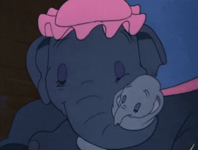 A Close Up Of A Cartoon Elephant With A Pink Hat On Its Head GIF