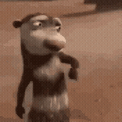A Close Up Of A Cartoon Opossum Standing On A Sandy Beach . GIF