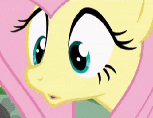 A Close Up Of A Cartoon Pony 'S Face With Big Blue Eyes And Black Eyelashes . GIF