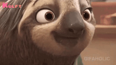 A Close Up Of A Cartoon Sloth Making A Funny Face And Smiling . GIF
