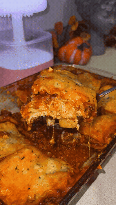 A Close Up Of A Casserole Dish With A Spoon In It GIF