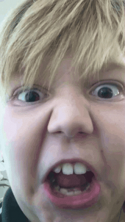 A Close Up Of A Child Making A Funny Face GIF