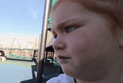 A Close Up Of A Child 'S Face In A Park GIF