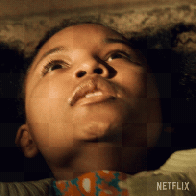 A Close Up Of A Child 'S Face With A Netflix Logo Behind Her GIF