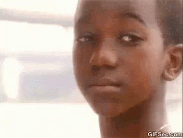 A Close Up Of A Child 'S Face With A Serious Look On His Face . GIF