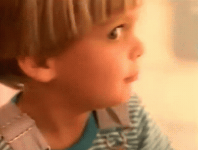 A Close Up Of A Child 'S Face With A Striped Shirt On GIF
