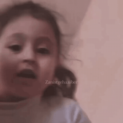 A Close Up Of A Child 'S Face With The Words Zanistgeha.siber On The Bottom Right GIF