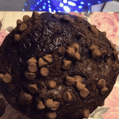 A Close Up Of A Chocolate Muffin With Chocolate Chips On It GIF