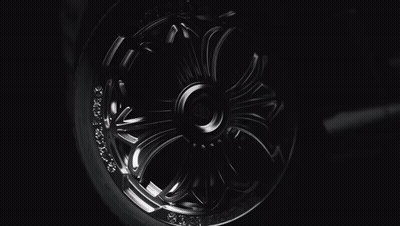 A Close Up Of A Chrome Wheel With The Letter H On The Center GIF