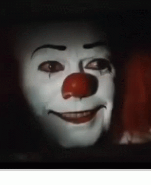 A Close Up Of A Clown 'S Face With A Red Nose Smiling . GIF