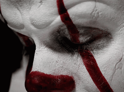 A Close Up Of A Clown 'S Face With Red Lines GIF