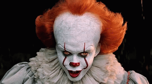 A Close Up Of A Clown With Red Hair GIF