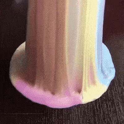 A Close Up Of A Colorful Slime On A Table . GIF