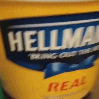 A Close Up Of A Container Of Hellmans Mayonnaise GIF
