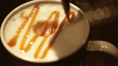 A Close Up Of A Cup Of Coffee With Caramel Sauce GIF