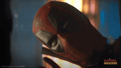 A Close Up Of A Deadpool Mask With The Words Deadpool Wolverine On The Bottom Right GIF