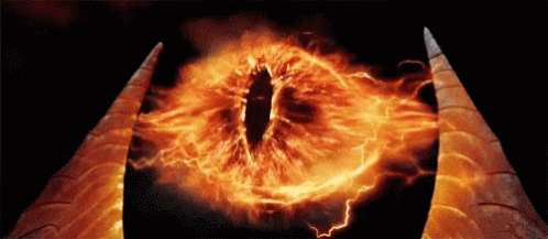 A Close Up Of A Demon 'S Eye With Flames And Lightning Coming Out Of It GIF