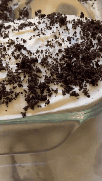 A Close Up Of A Dessert With Oreos On Top GIF