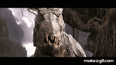 A Close Up Of A Dinosaur 'S Face With A Mountain In The Background GIF