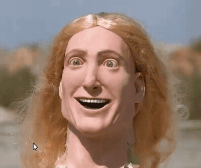 A Close Up Of A Doll 'S Face With A Large Smile On It GIF