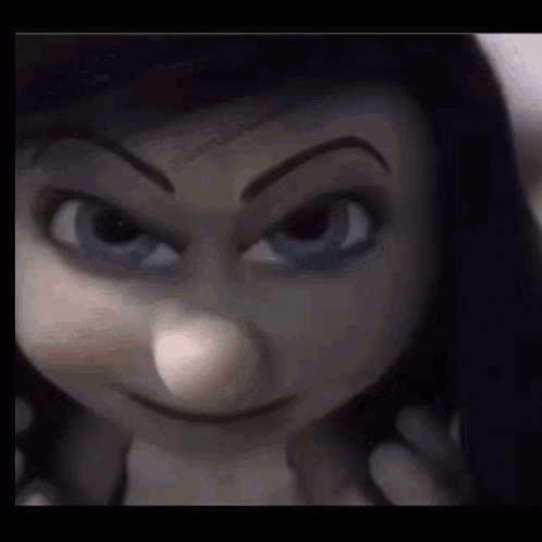 A Close Up Of A Doll 'S Face With A Serious Look On It . GIF