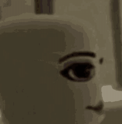 A Close Up Of A Doll 'S Face With A Smile . GIF