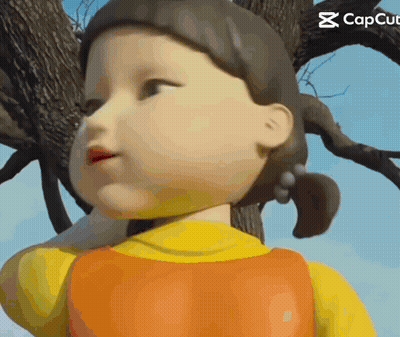 A Close Up Of A Doll 'S Face With A Tree In The Background . GIF
