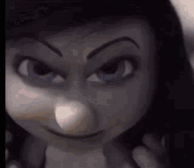 A Close Up Of A Doll 'S Face With An Angry Look On It . GIF