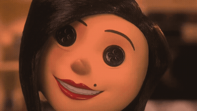 A Close Up Of A Doll 'S Face With Buttons In Her Eyes GIF