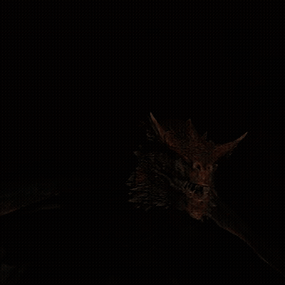 A Close Up Of A Dragon 'S Head Showing Its Teeth GIF